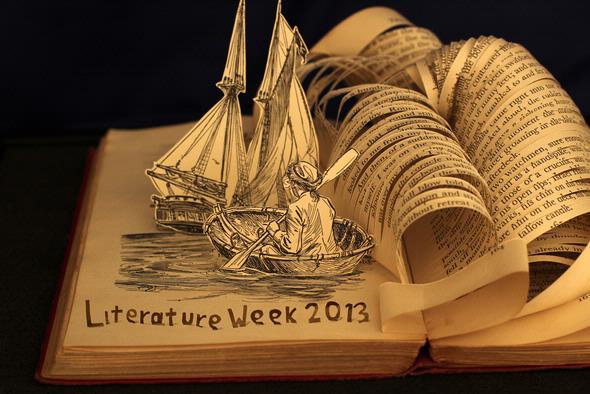 A page of a book cut and folded into a boat and water
